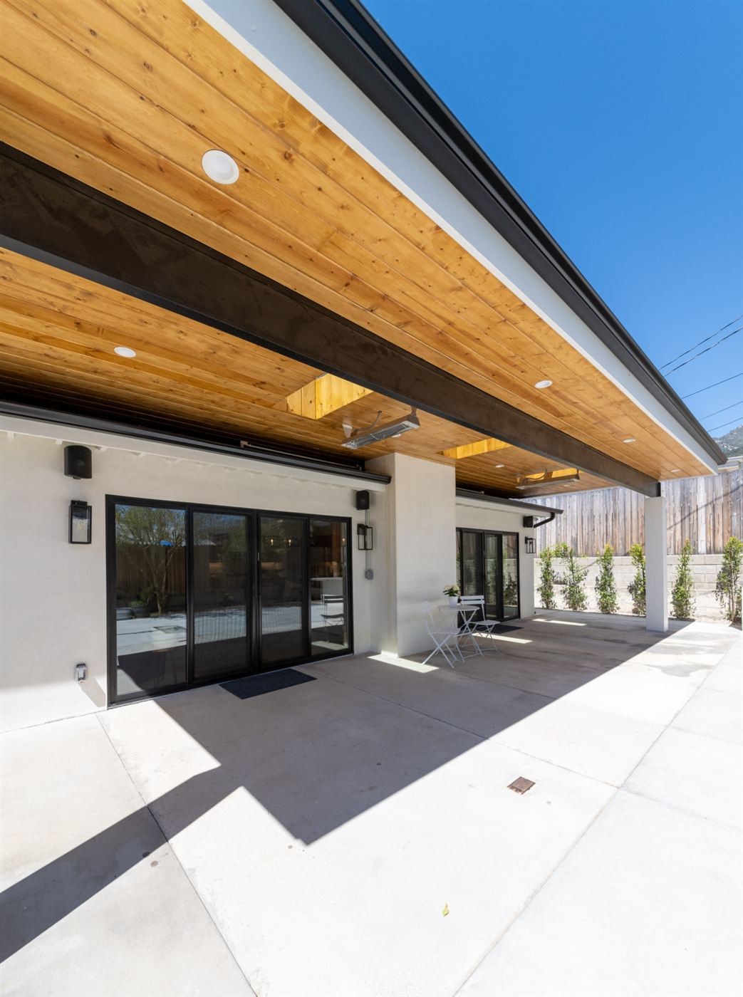 Modern single-story white house exterior with overhang