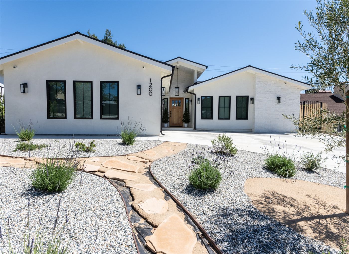 Front exterior with white stucco and dark trim