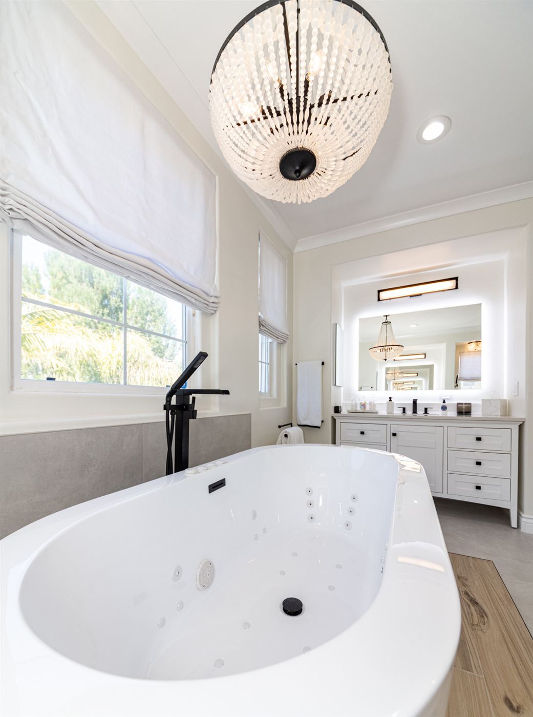 Westlake Village bathroom remodel — freestanding tub on wood platform with matte black fixtures